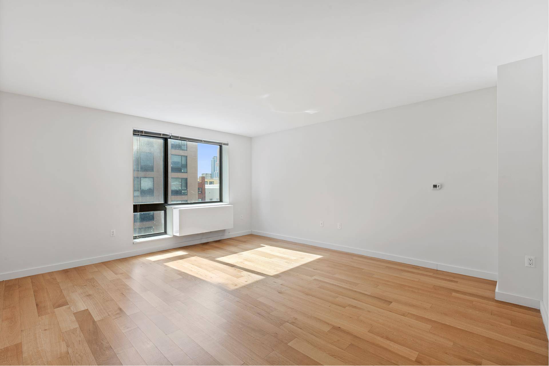 AVAILABLE IMMEDIATELY VIRTUAL TOURS AVAILABLE RENT STABILIZED BUILDING NO SECURITY DEPOSIT REQUIRED WITH A SMALL FEE TO RHINO Located in Hunters Point, this expansive 1 bedroom residence boasts an open ...