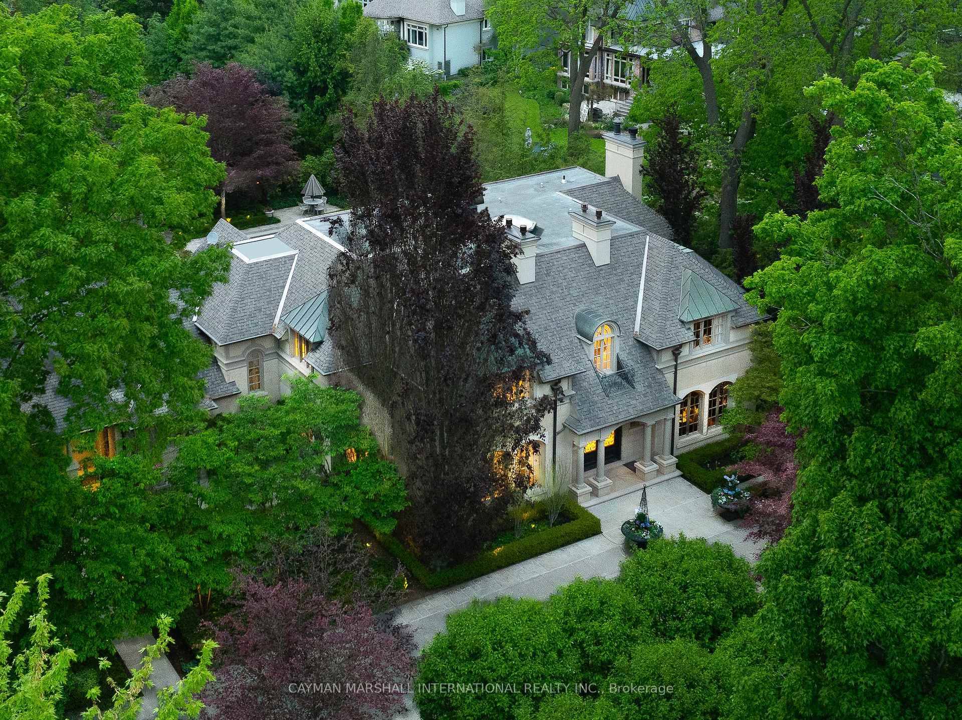 Gated, concealed, and surrounded by mature trees, 1021 Lakeshore Road East is one of South Oakville's most private residences.