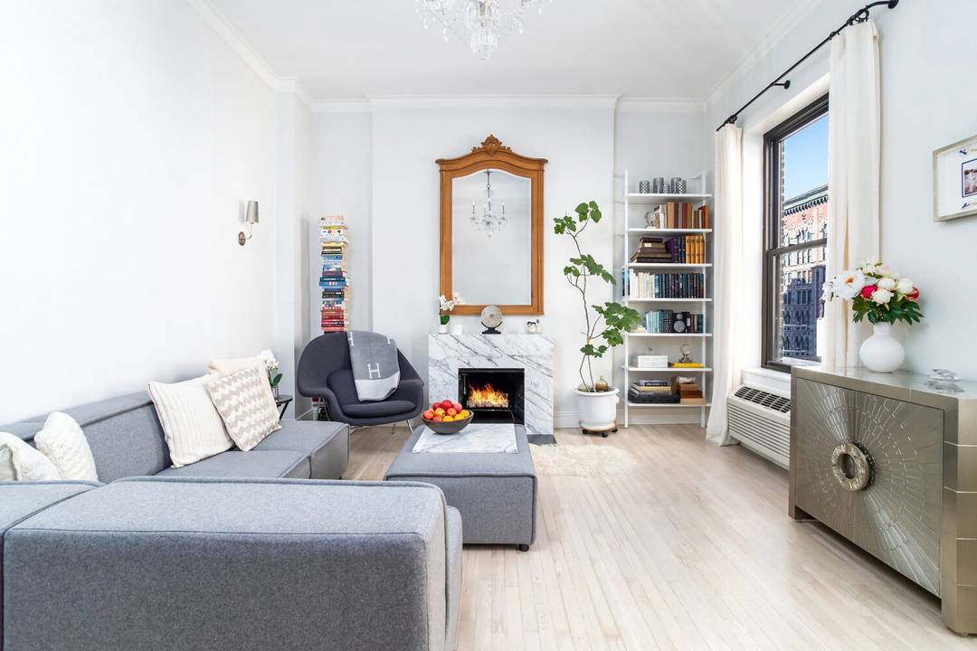 Light filled and impeccably renovated top floor UES Residence with high ceilings and wood burning fireplace.