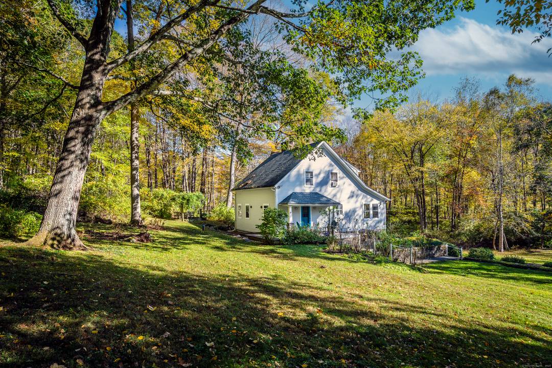 Set well back from the road across Bull Mountain Brook is this incredibly private brookside home on South Kent's lauded Geer Mountain Rd.