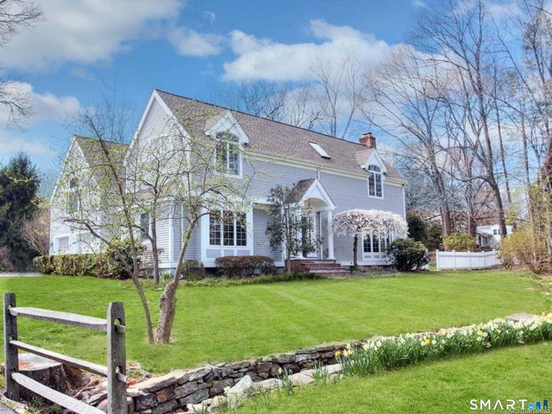 Welcome to your Westport retreat, tucked away on a private street with a peaceful brook flowing just outside.