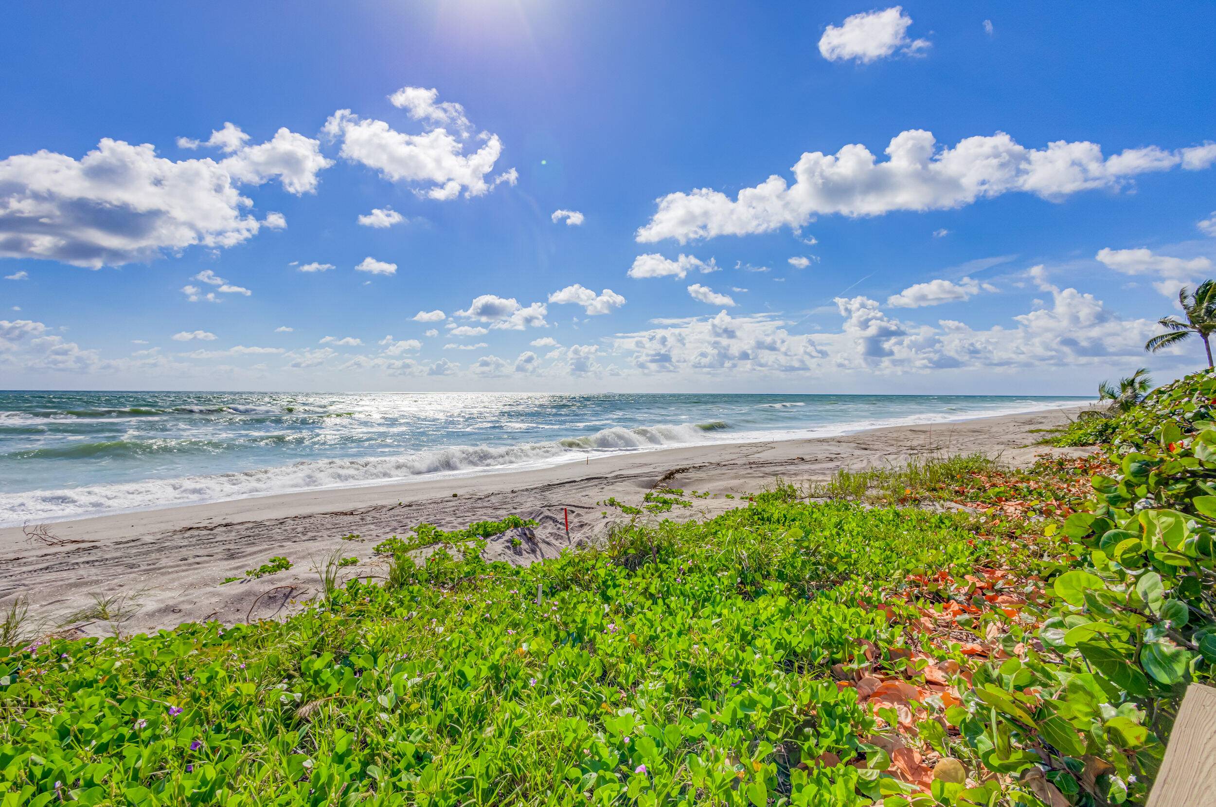 Walk to beach from this corner unit with partial ocean views.