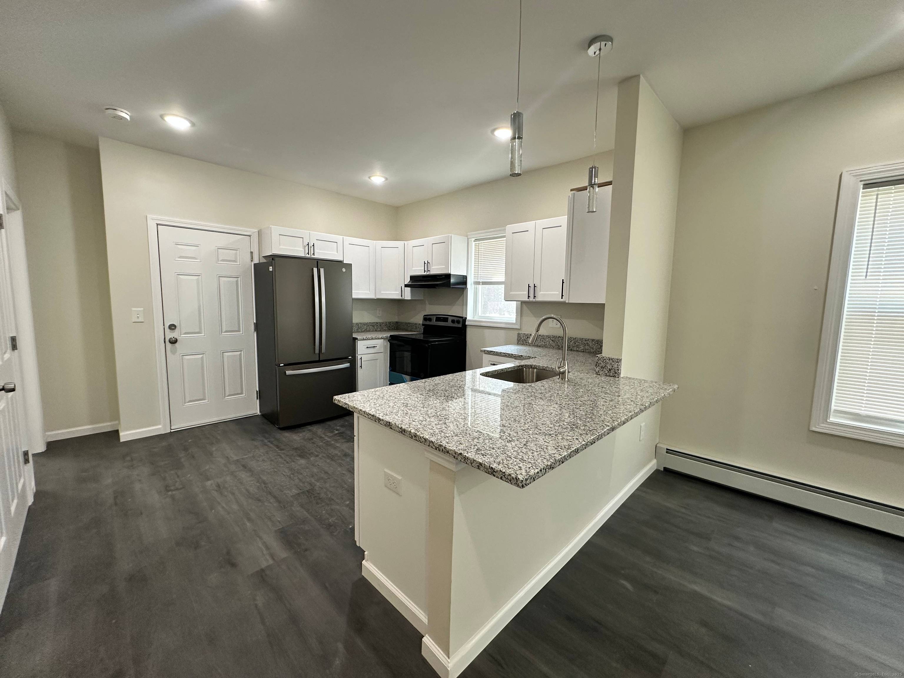 Fall in love with this beautifully redesigned three story two family home in Hartford's vibrant North End, just minutes from downtown.