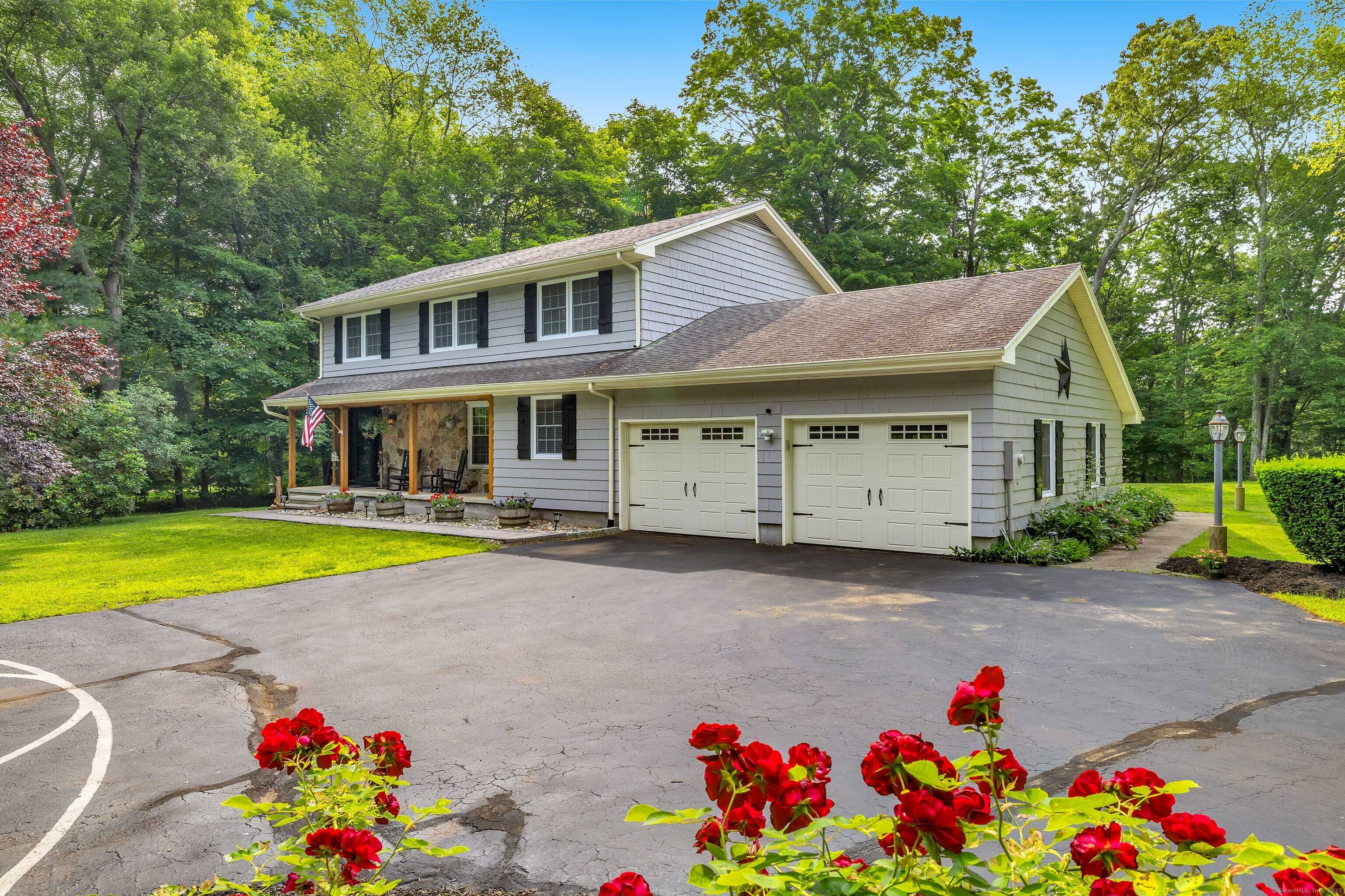 Welcome to 2 Naomi Lane where comfort, space, and New England charm come together on nearly an acre of private, level land in sought after East Lyme.