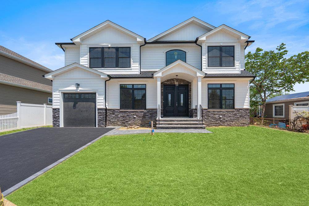 Completed New Construction home on a stunning mid block location in east meadow.