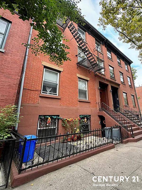 Elegant Legal Three Family Townhouse with Garden Apartment and Cellar.