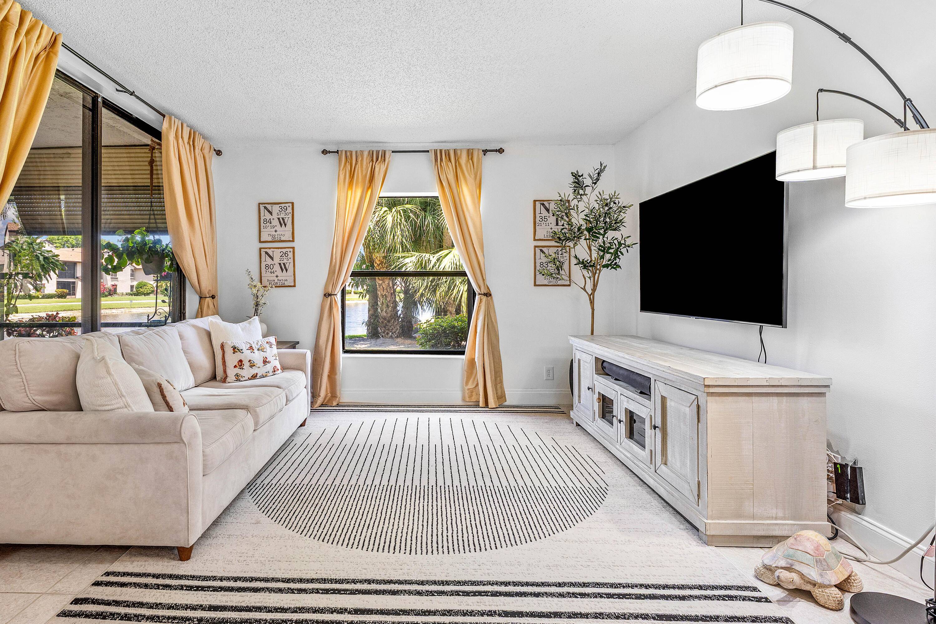 Ground floor corner unit with beautiful lake views in an all ages, gated Boca Raton community.