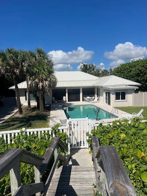 Exquisite oceanfront estate on prestigious Jupiter Island, fully renovated to embody coastal luxury.