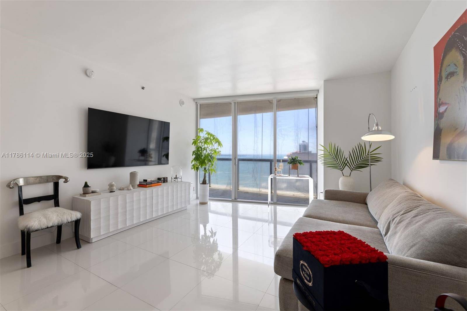 A beautifully furnished 1 Bed, 1 Bath condo w over 1, 000 interior sq ft, white porcelain tiled floors in living areas, marble floors in the bathroom, motorized shades, a ...