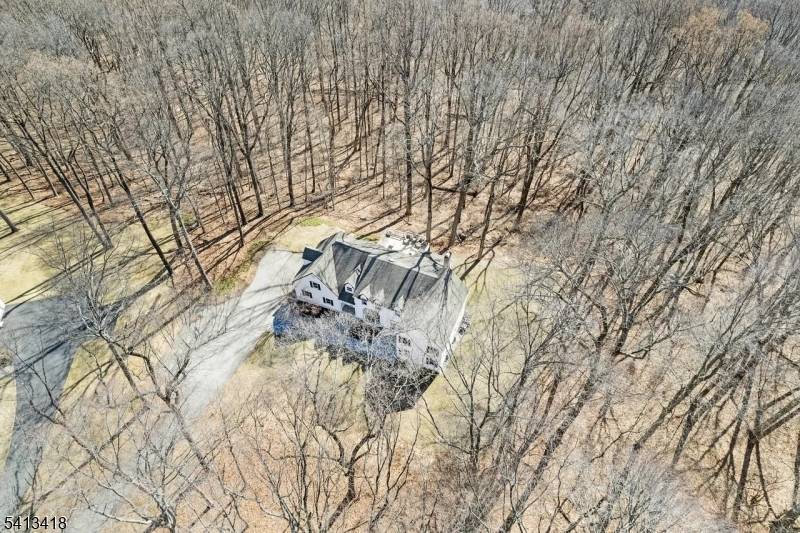 Welcome to this beautifully reimagined 4, 437 square foot Colonial, privately nestled on 4.