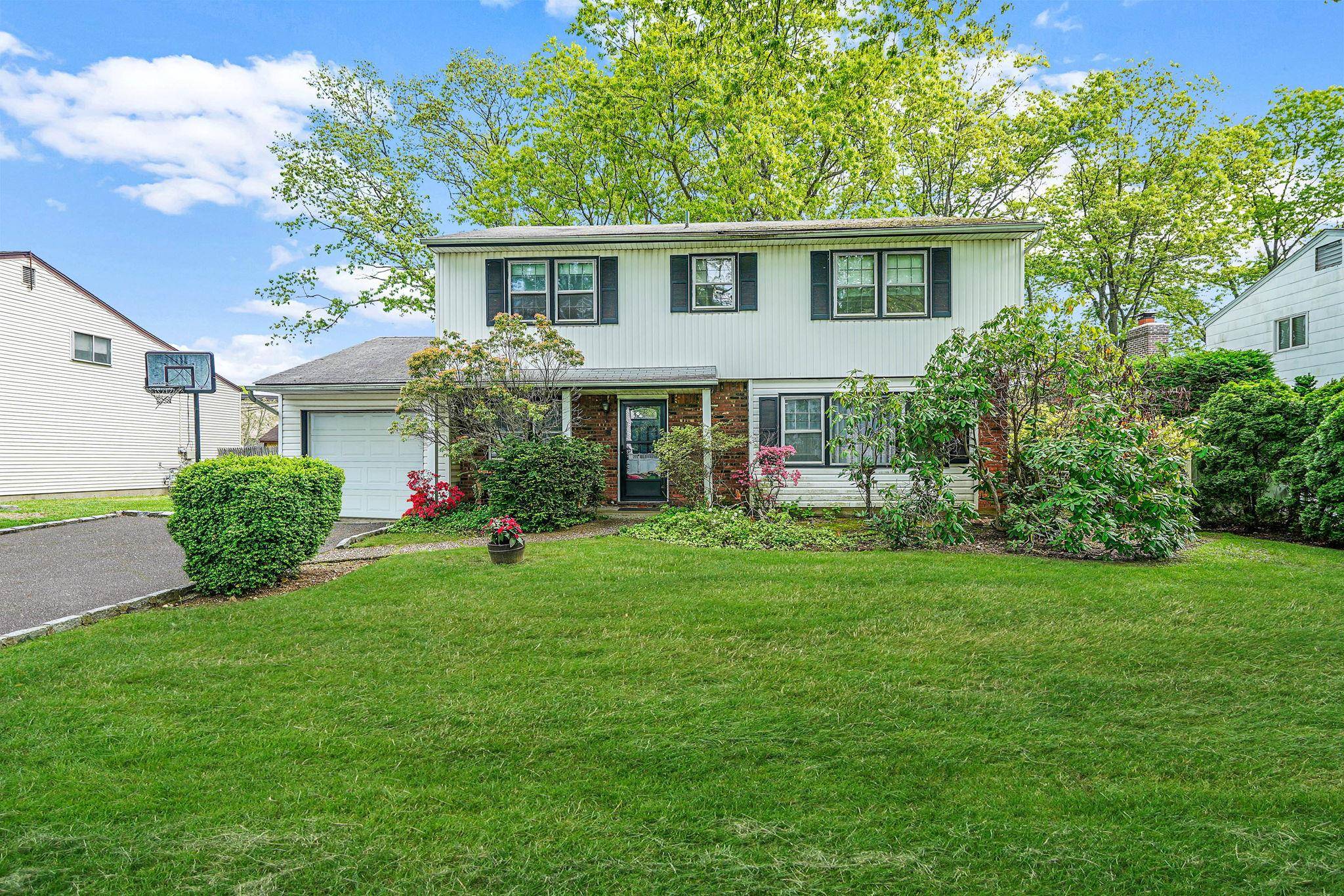 Welcome Home to your charming Center Hall Colonial, a beautifully maintained residence ready for you to personalize and make your own.