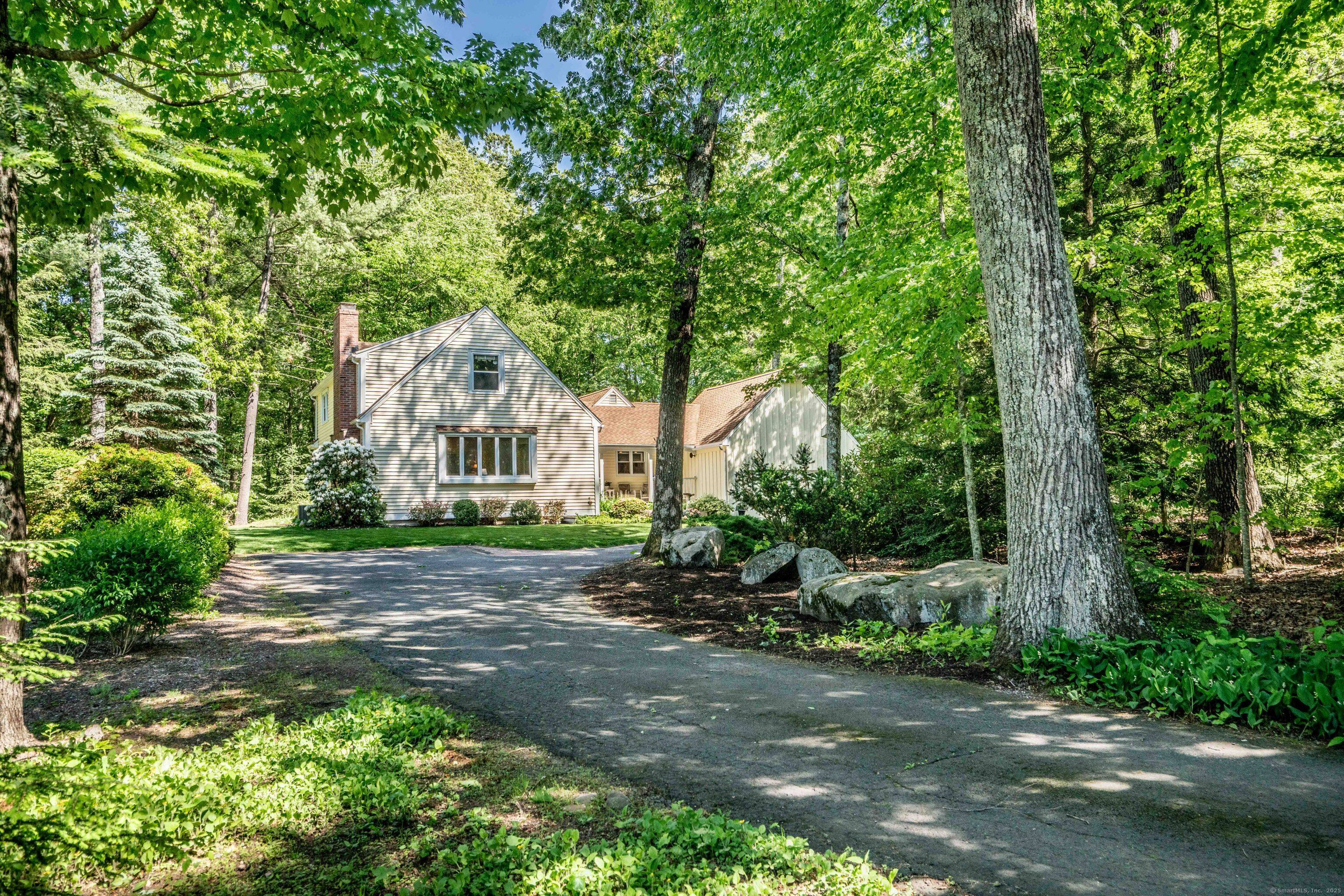 MOVE IN READY. A private, winding drive leads to this charming, well cared for cape surrounded by lush yard and flowering gardens.