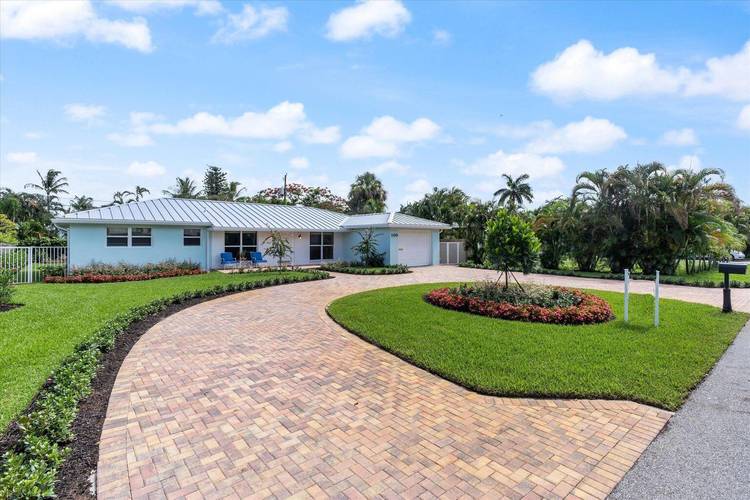 Nestled in a premier Delray Beach neighborhood characterized by 4M estates, this charming ranch home is a sanctuary of modern comfort.