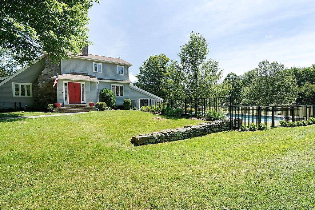 Pristine barn style home on scenic dirt road with stream and small ponds.