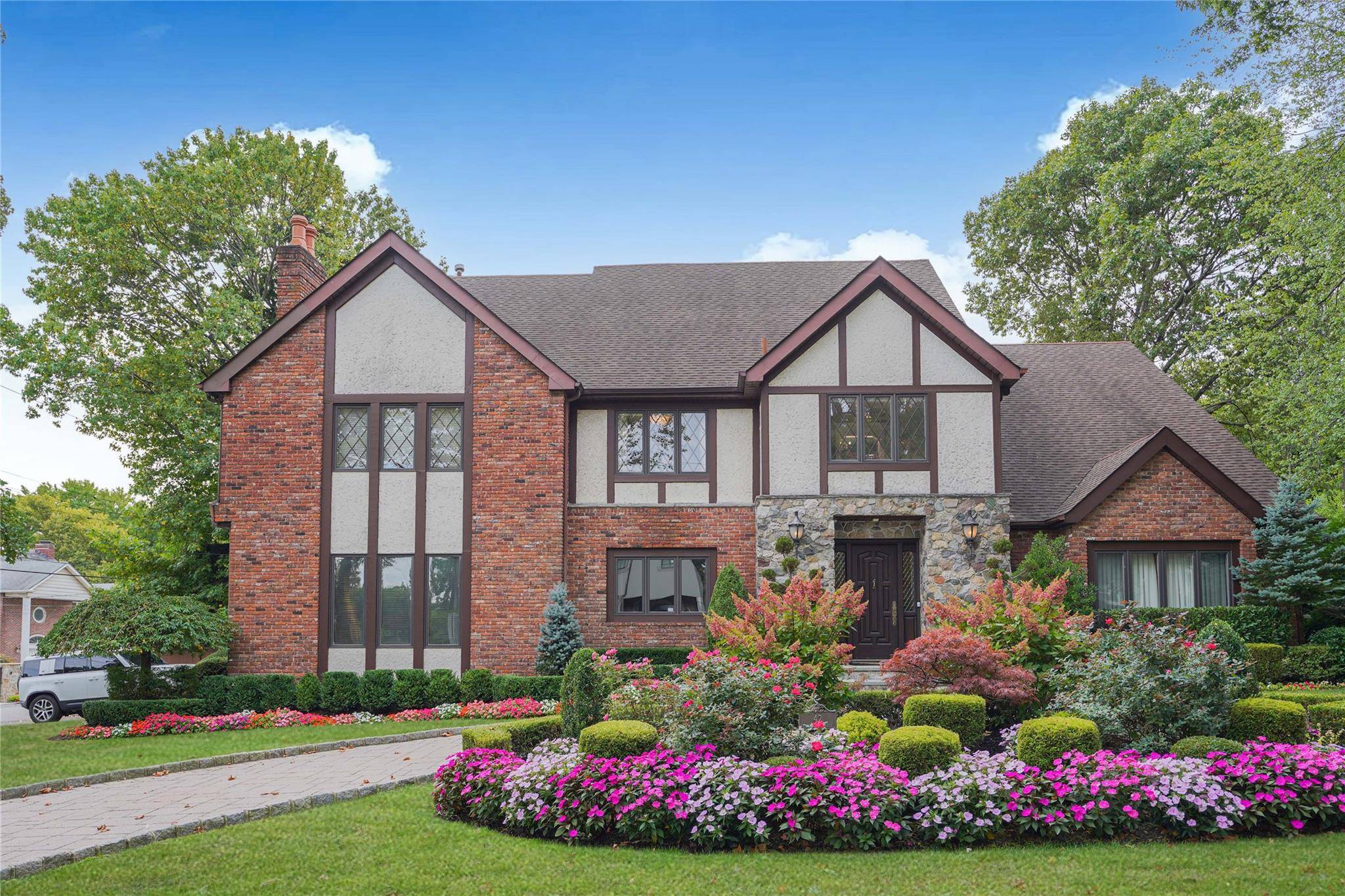Nestled in one of the most desirable neighborhoods of Todt Hill, this exquisite 5 bedroom, 4 bath Tudor home masterfully blends classic charm with modern sophistication.