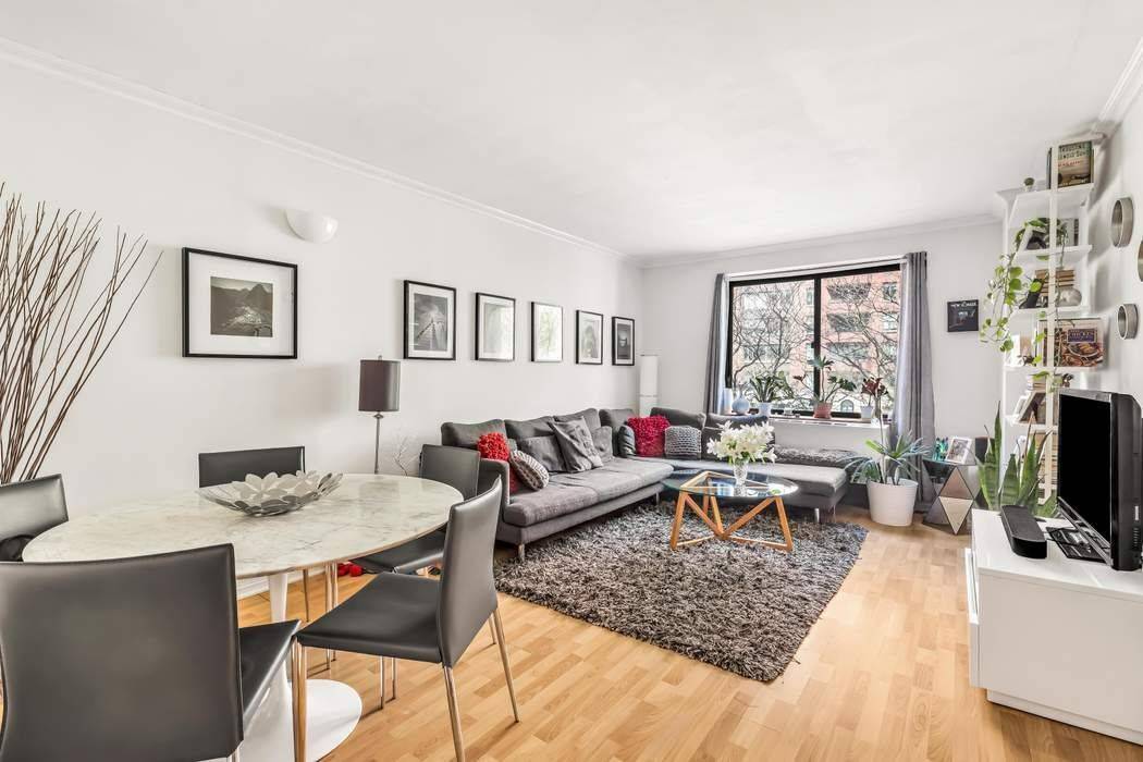 Light floors, and oversized windows create an inviting, airy ambiance with abundant natural light throughout the home.