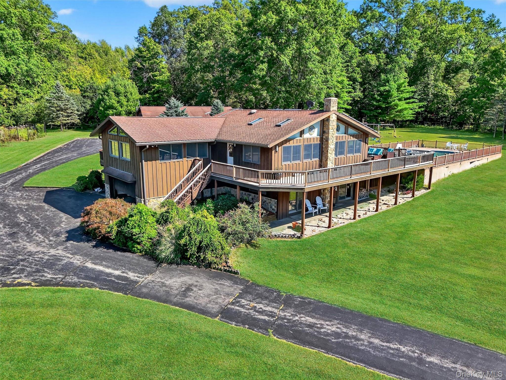 Set high on a rolling hilltop, this stunning contemporary ranch offers panoramic views that stretch for miles.