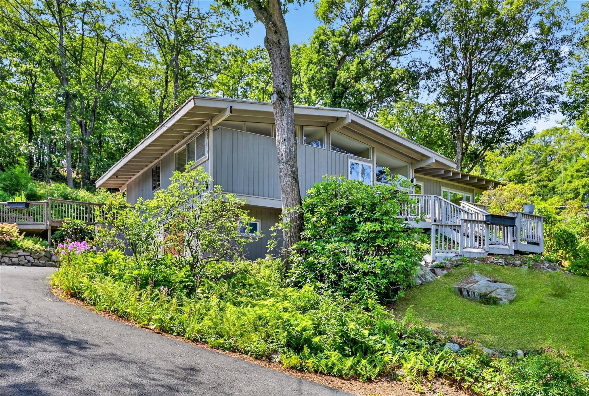 Set high on a peaceful acre with a stunning mountain backdrop, this fully remodeled contemporary in Tuxedo is your everyday escape.