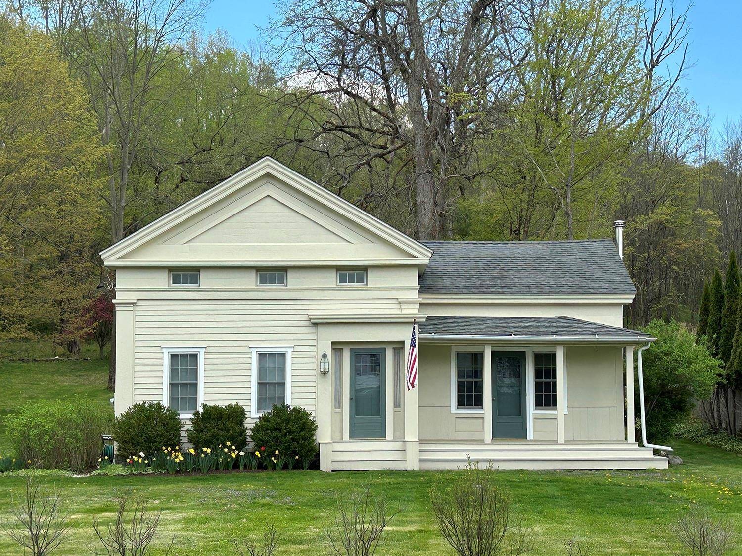 This quintessential classic Greek Revival Eyebrow home, circa 1850, is located in a historic quiet country Hamlet.