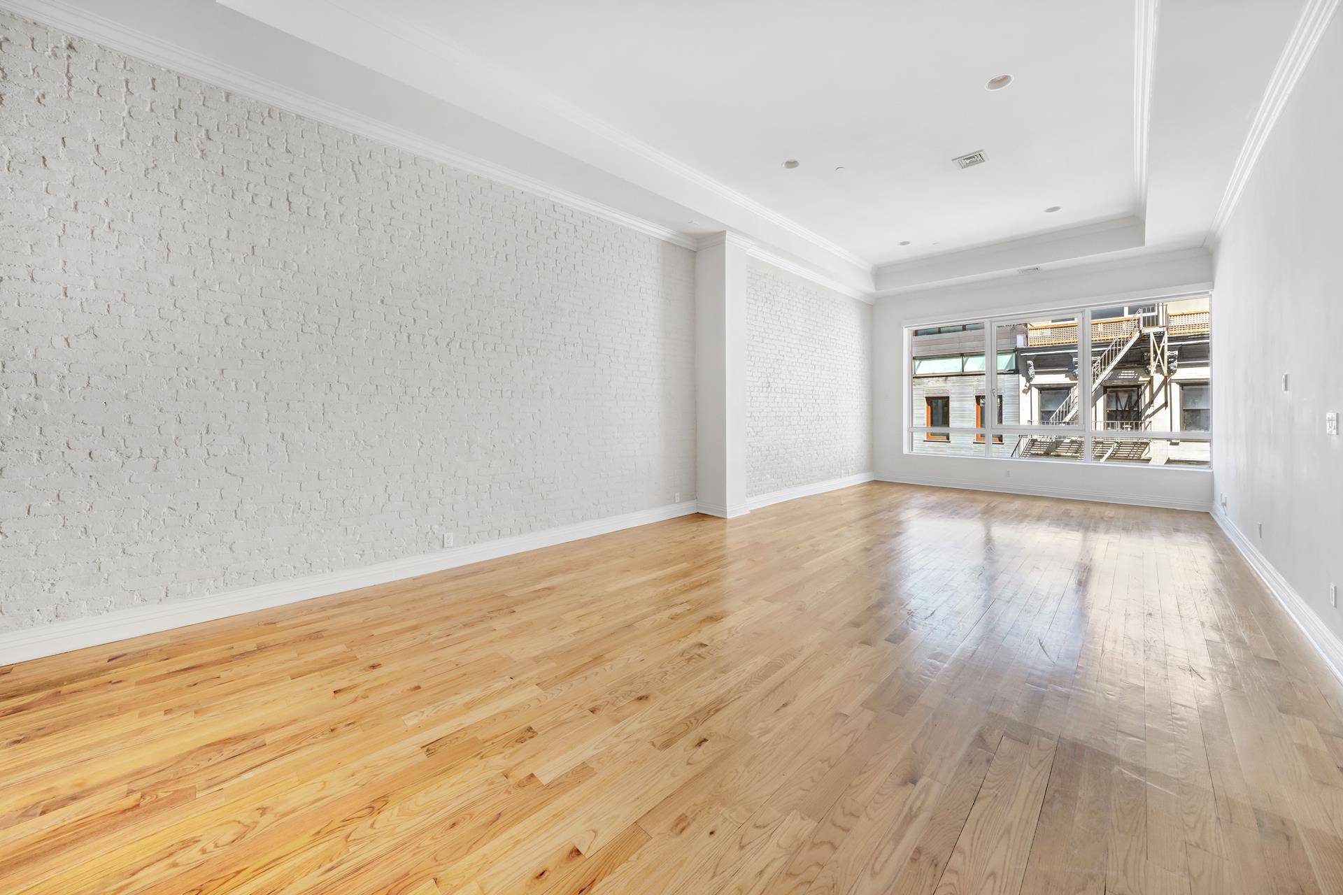 With over 29 feet of an exposed brick wall and approximately fourteen foot ceilings, this two bedroom two bathroom unit has all the character of true downtown loft living.