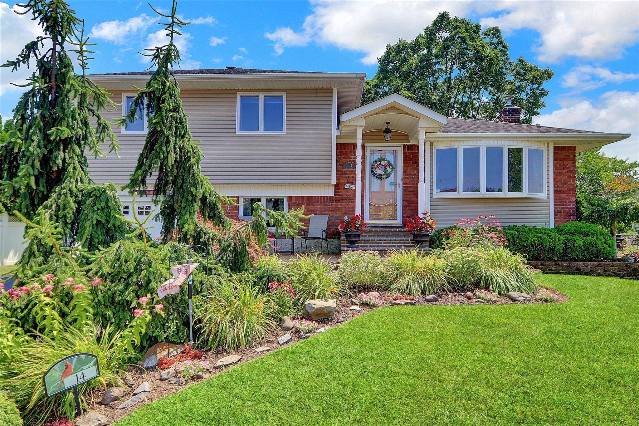 The lush front garden and paved entry path lead to this tastefully updated 3 br 1.