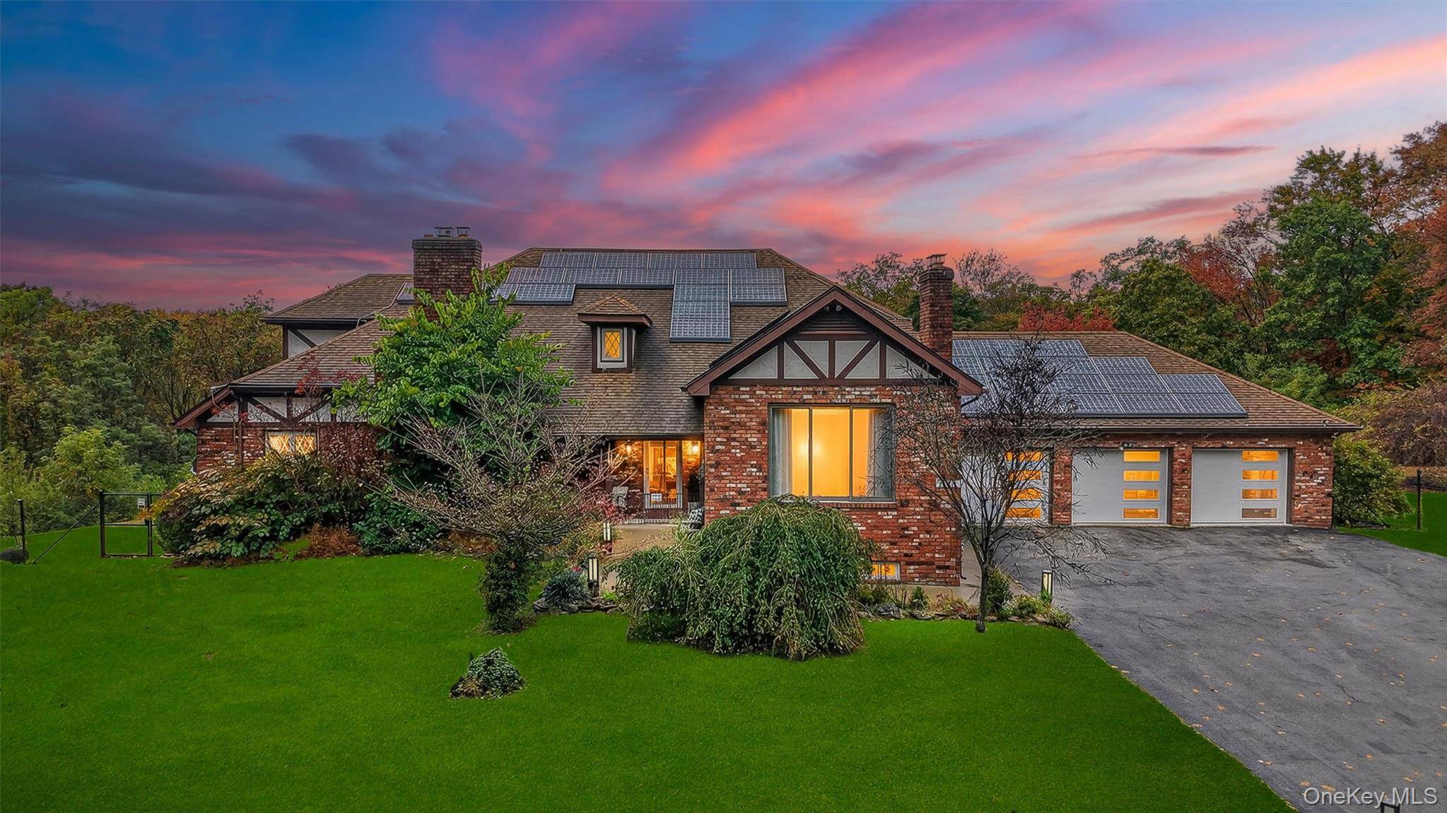 Set on over 22 acres of rolling landscape, this exquisite Tudor sanctuary embodies timeless beauty and modern refinement.