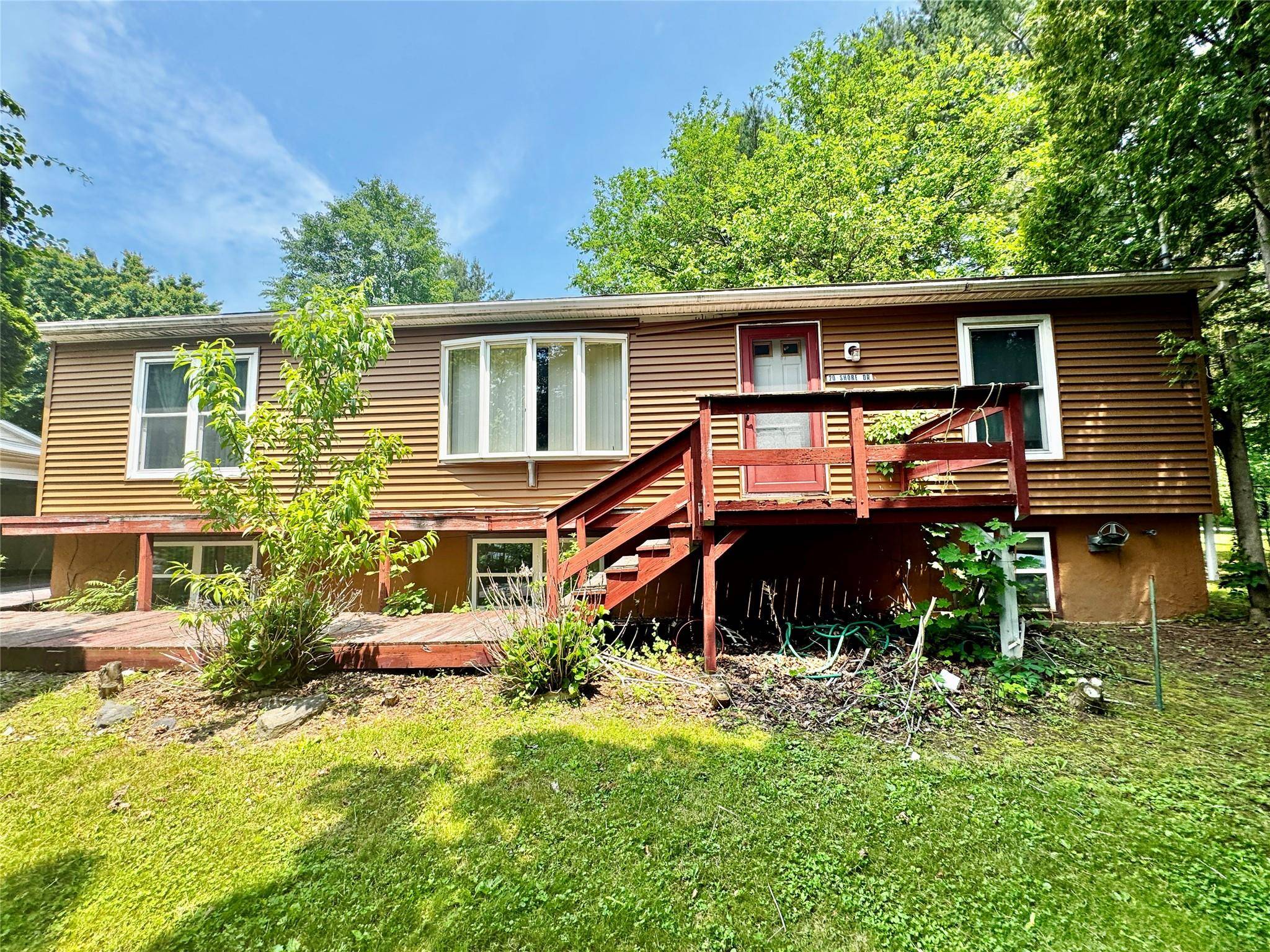 Imagine waking up to the gentle sounds of lake life, stepping out onto your expansive corner lot where morning coffee tastes better surrounded by the promise of mature gardens waiting ...