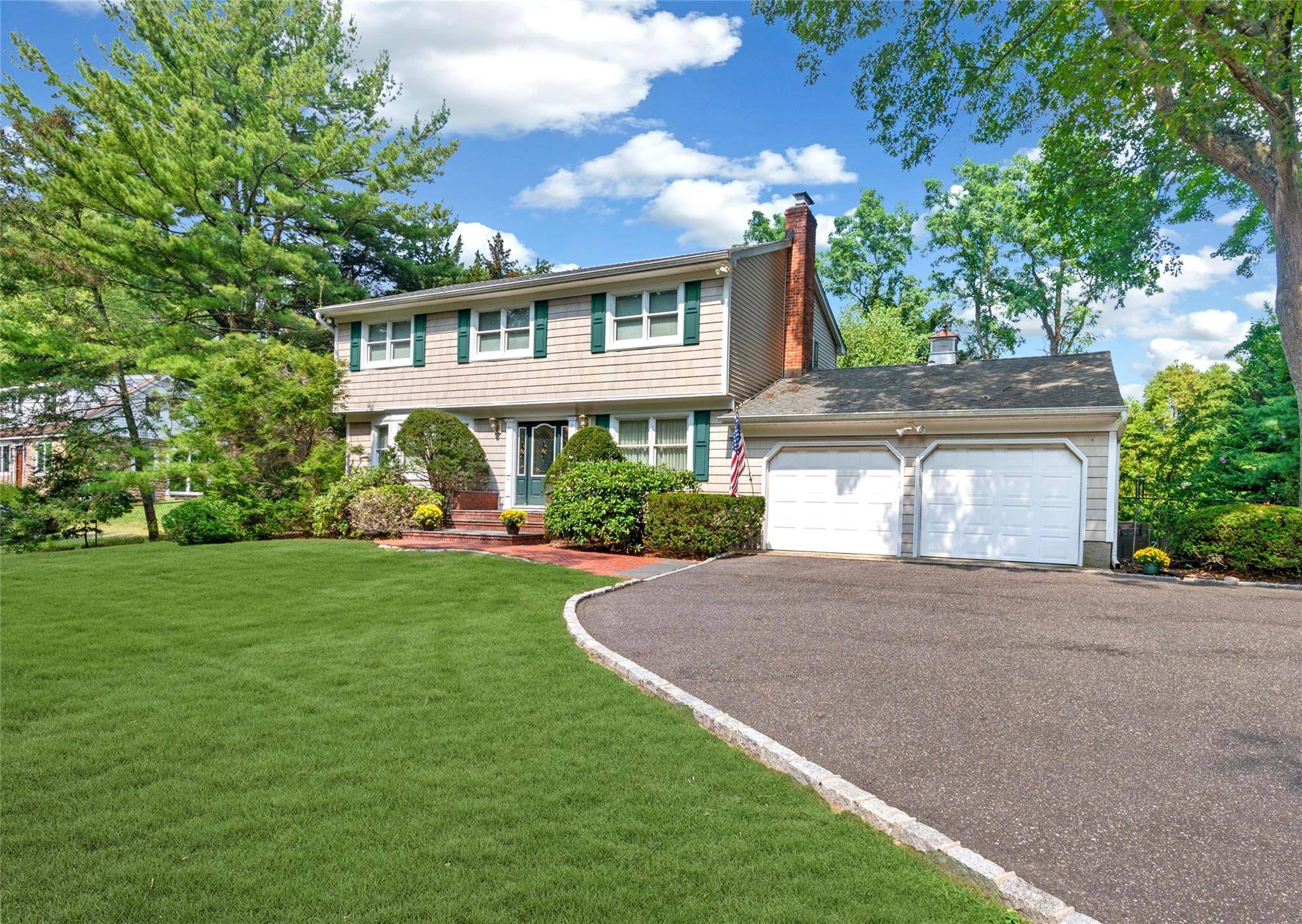 Nestled on a lush Half acre, this elegant Center Hall Colonial blends classic charm with modern comfort.