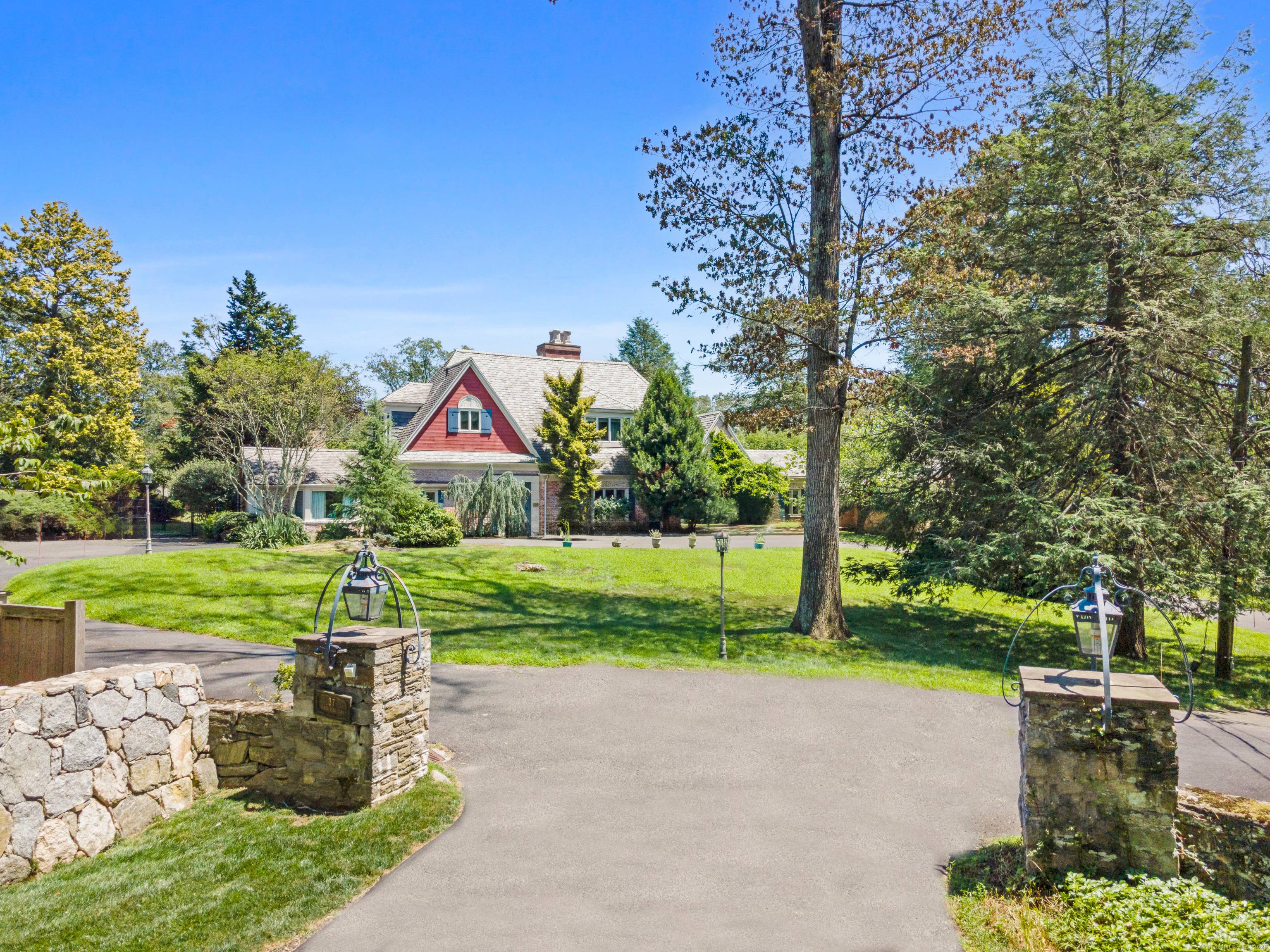 A rare investment opportunity to own a storied 1936 estate on a desirable, private street in the heart of Westport.