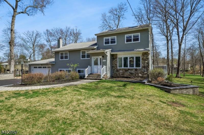 Welcome to a beautifully updated 3274 SF split level home set on an expansive and level 1.