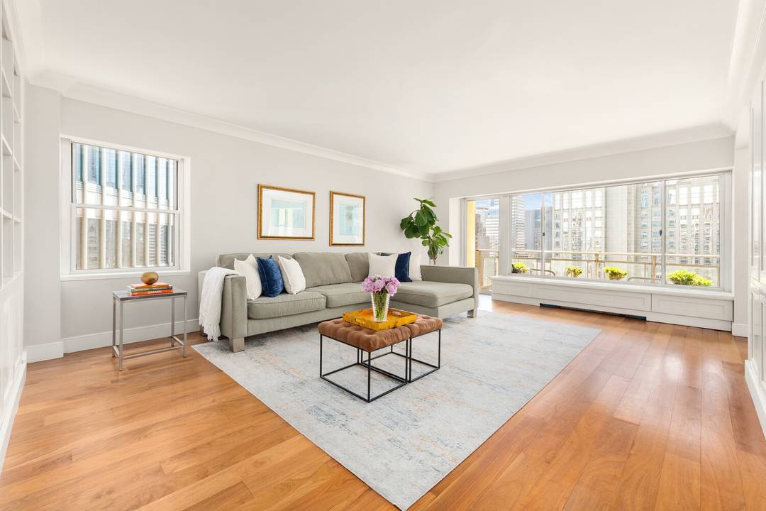 Sun drenched and beautifully appointed corner two bedroom, two bathroom residence just off Park Avenue, featuring sweeping southern city views, a private balcony, and thoughtfully designed interiors.