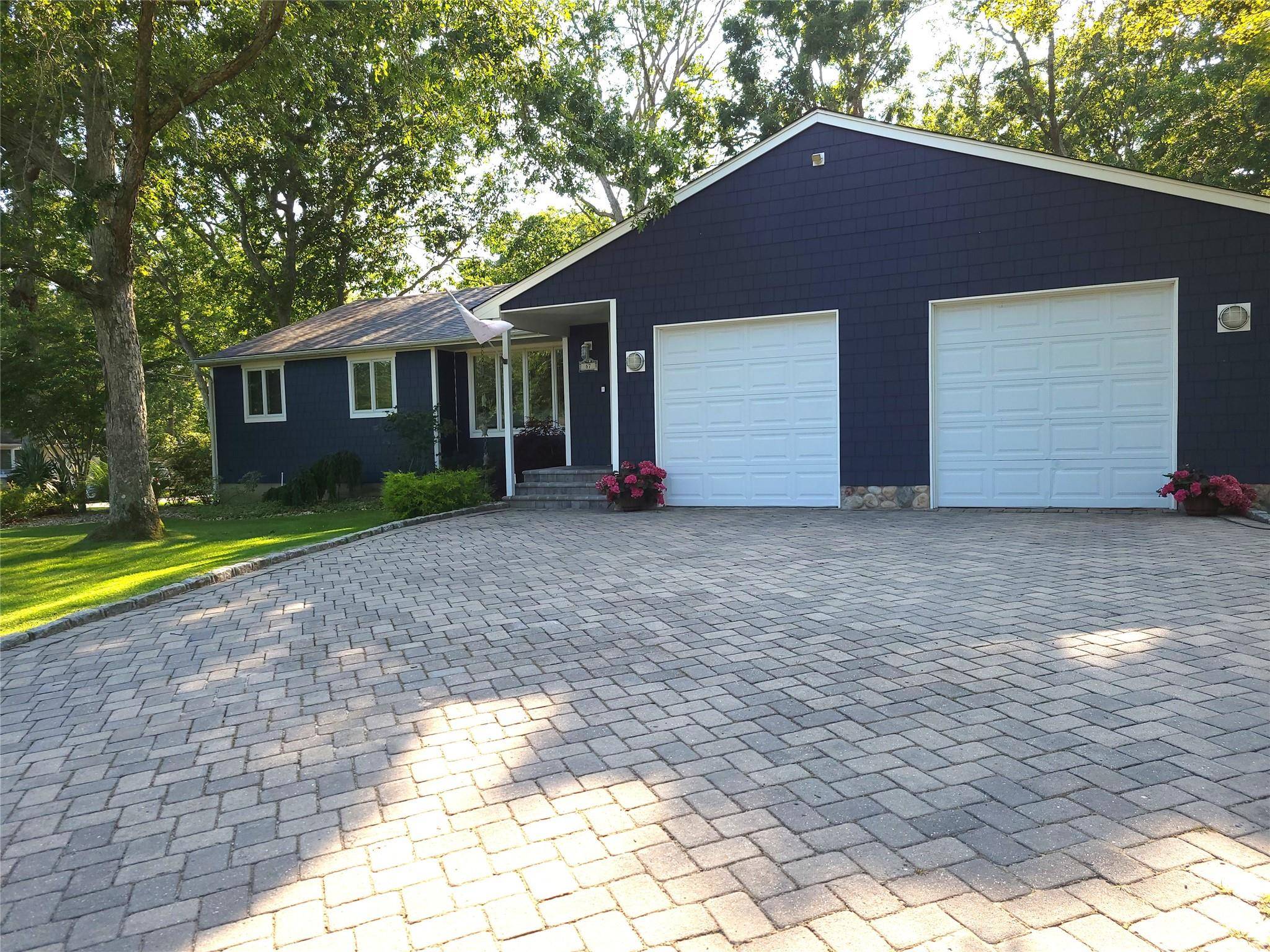 Enter into the living room area featuring Cathedral Ceilings, with an open floor plan to the kitchen and dining area.