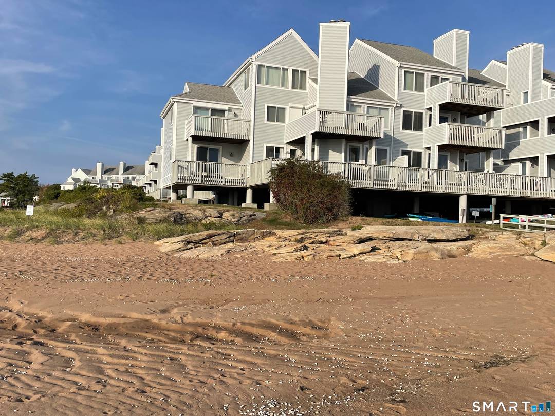 DIRECT WATERFRONT 1st floor end unit on the sandy beach ; open, renovated KIT w granite counters ; LR DR combo with wood burning FP and sliders to deck overlong ...