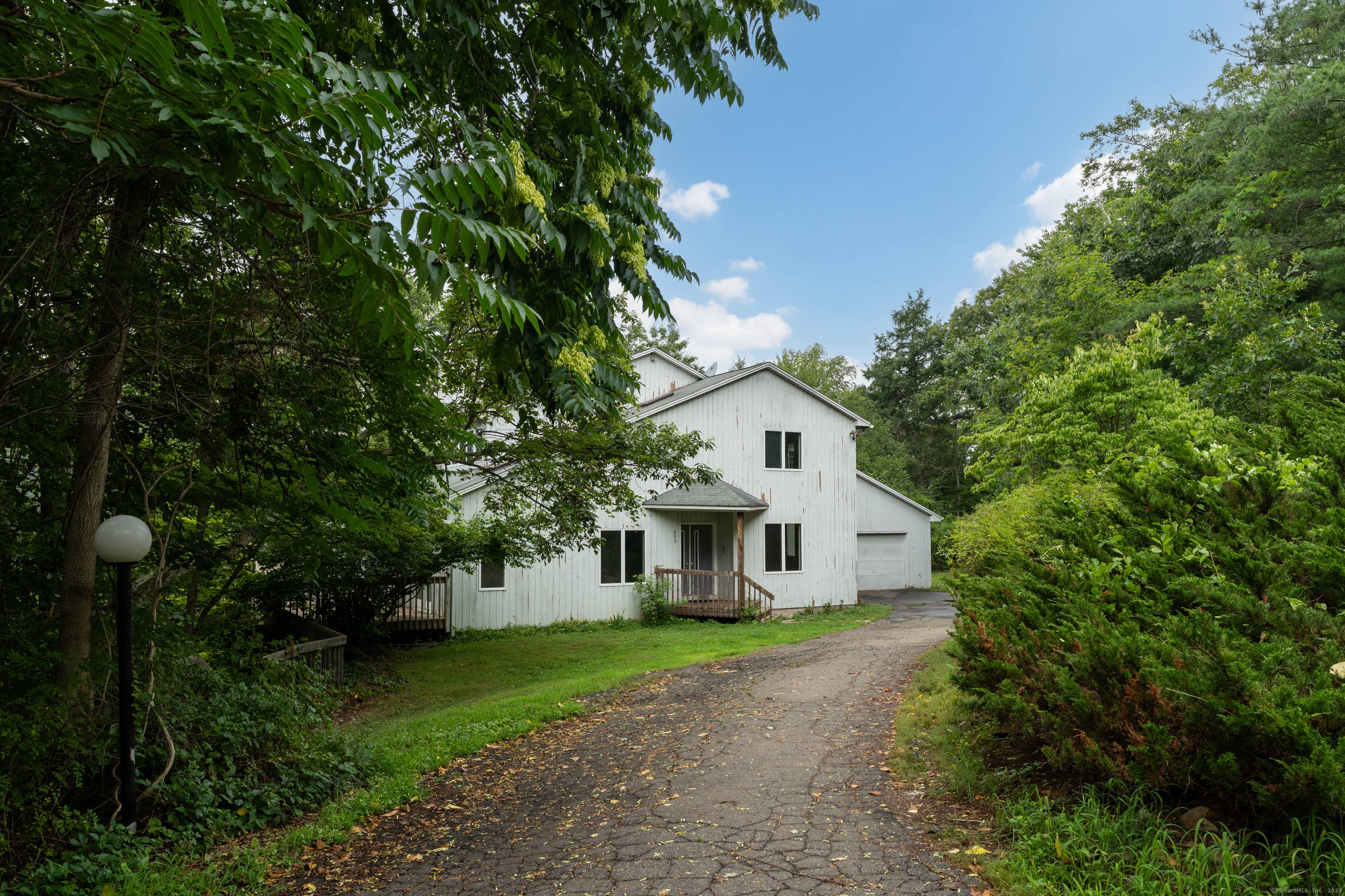 Perched atop a scenic hill on four acres, this stunning custom built home offers a blend of privacy, nature, and design.