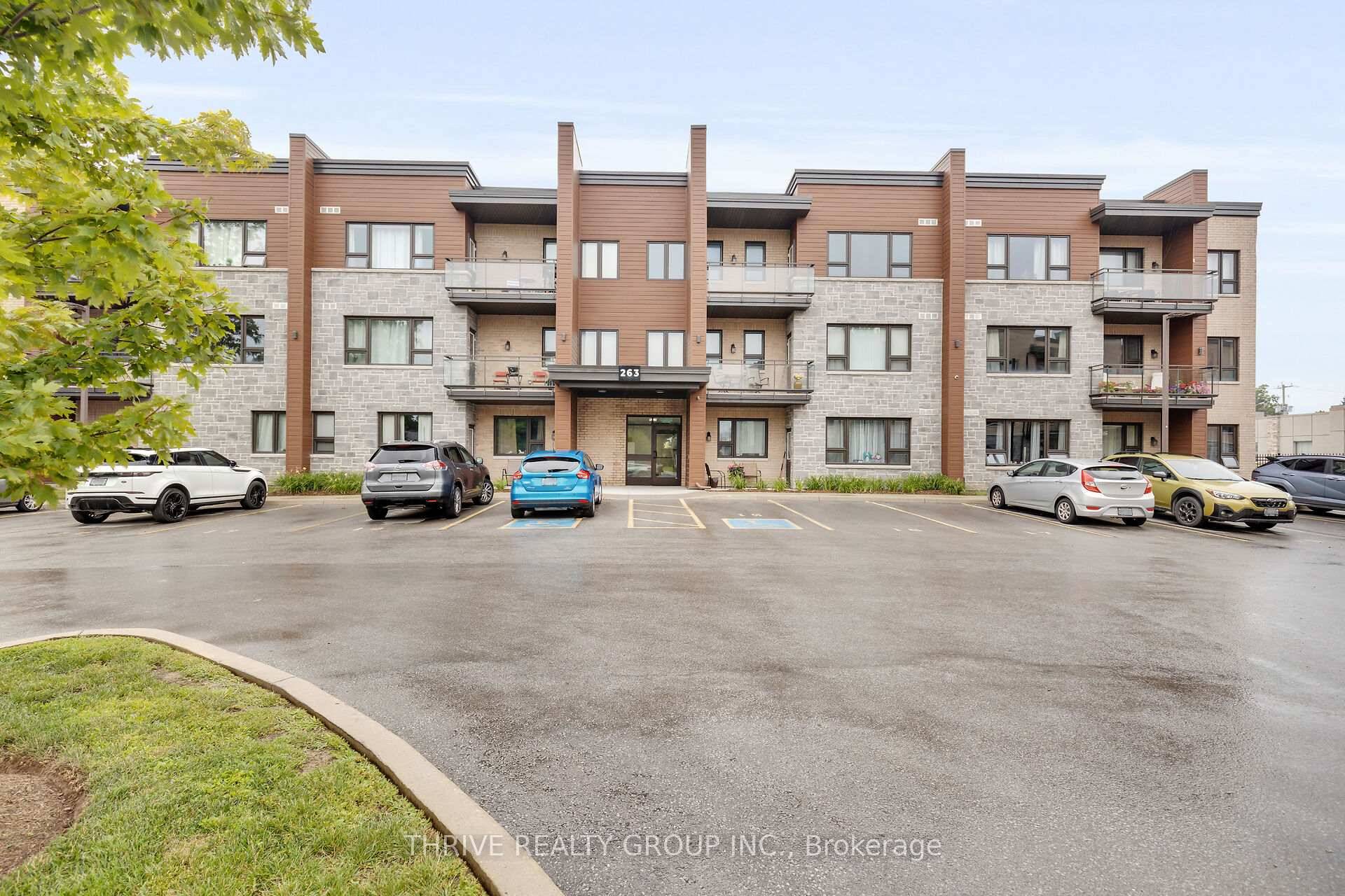 Step into this spacious top floor condo, featuring a generously sized kitchen adorned with timeless ceramic tile flooring and solid wood cabinetry offering plenty of storage.