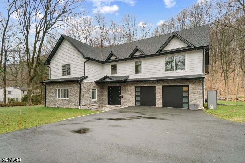 Tucked away on a quiet street and set on 2 acres, this newly built luxury home offers nearly 6, 000 sq ft of elegant living.