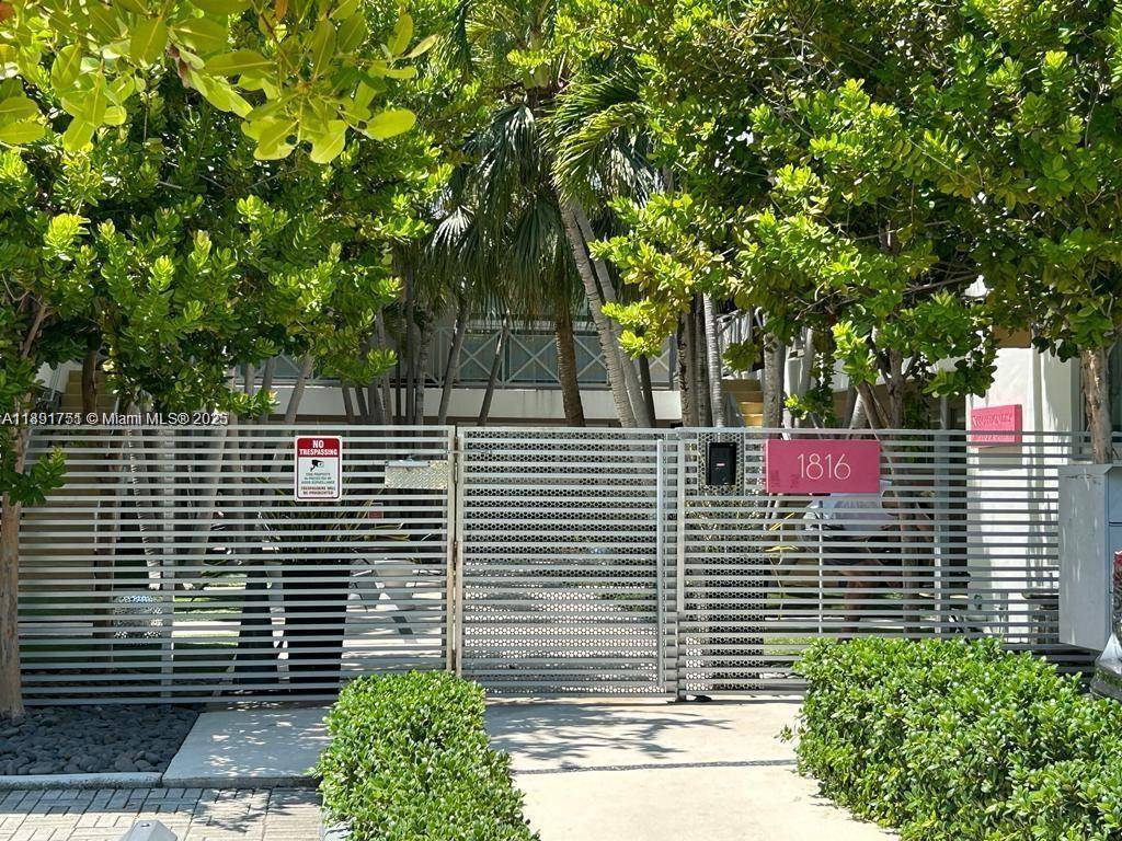 Charming Art Deco Condo hotel building, garden style with beautiful courtyard and tropical landscaping.