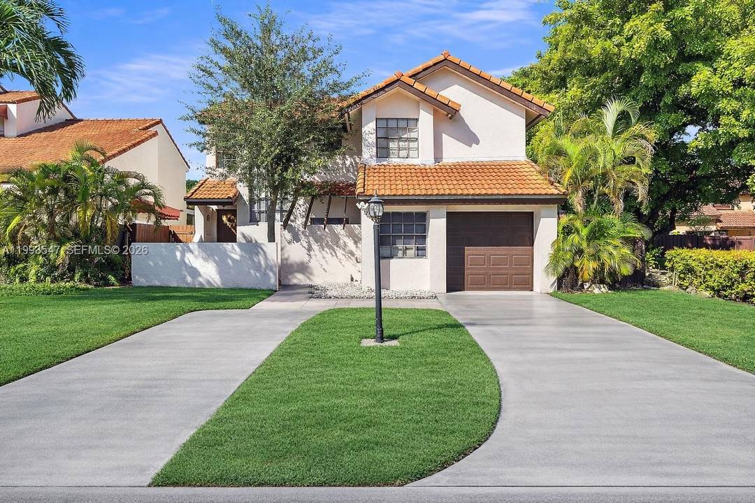 Beautiful two story corner home featuring four bedrooms and three bathrooms, as well as a garage and a spacious patio with a swimming pool.