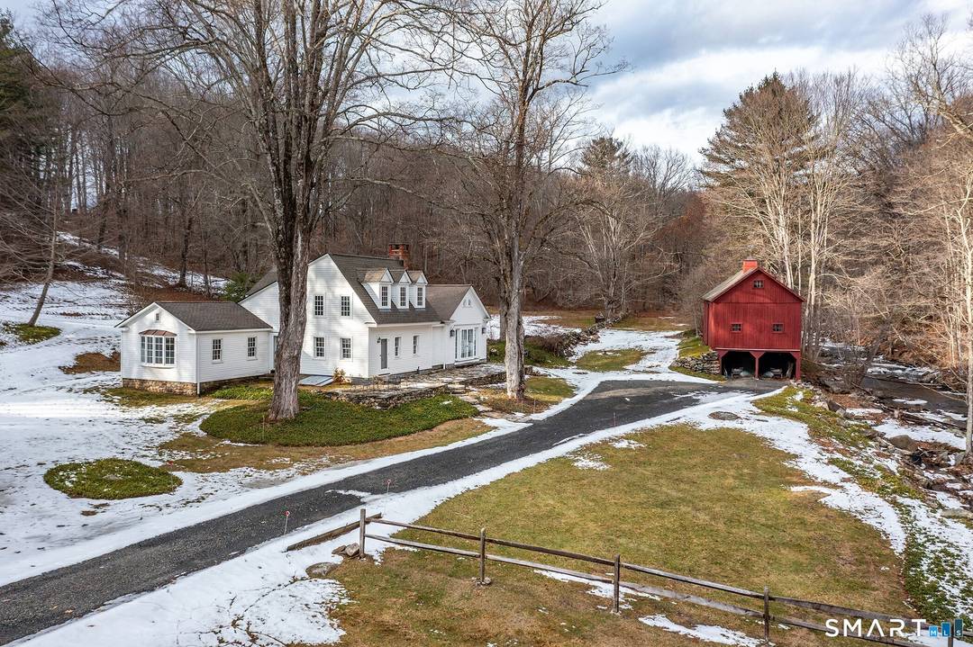 Circa 1790s antique colonial on 8 park like acres with historic barn and West Aspetuck River frontage offered as is.