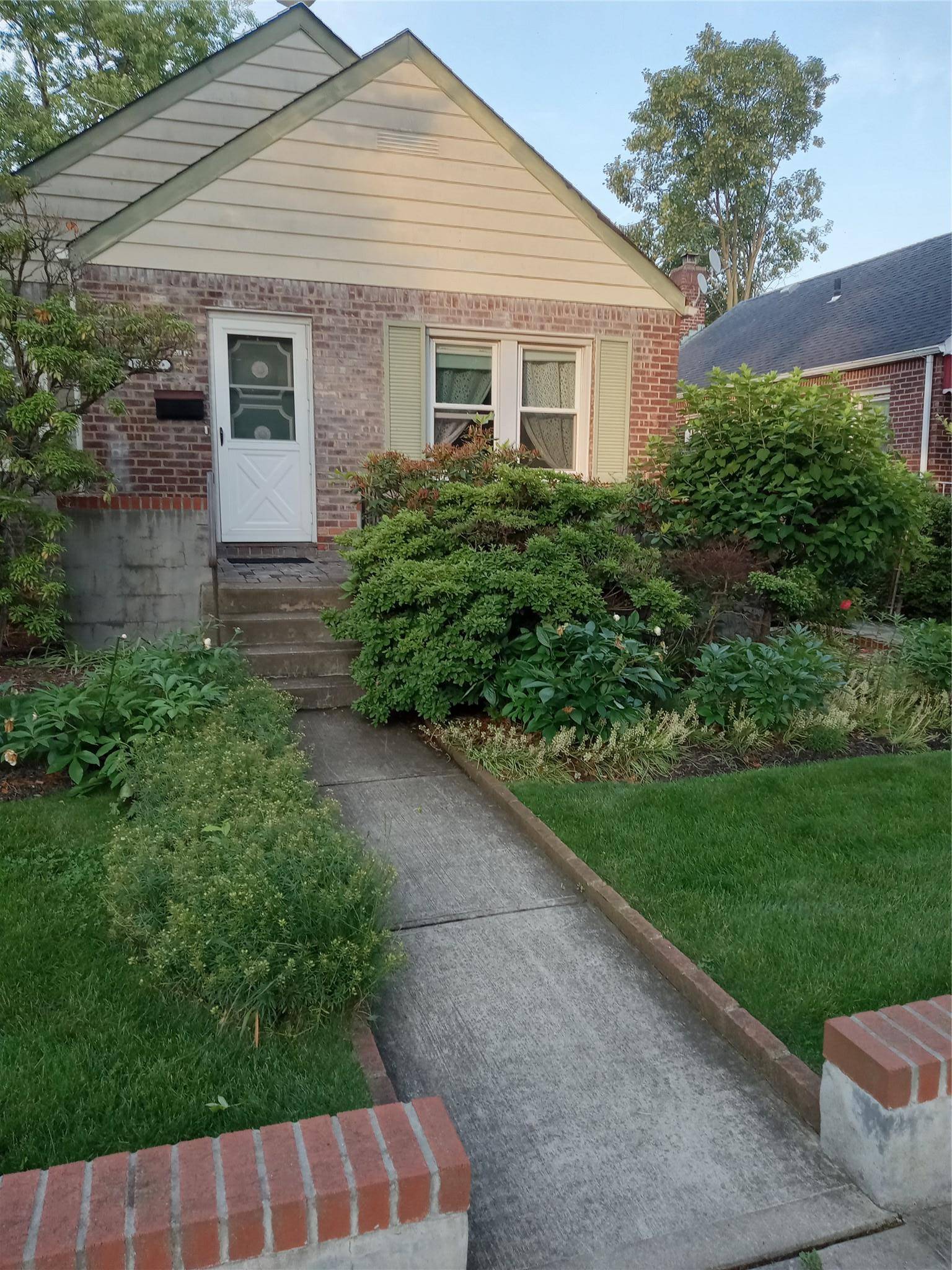 Two Bedroom one full bath Cape Cod style home with inviting open front cement porch.