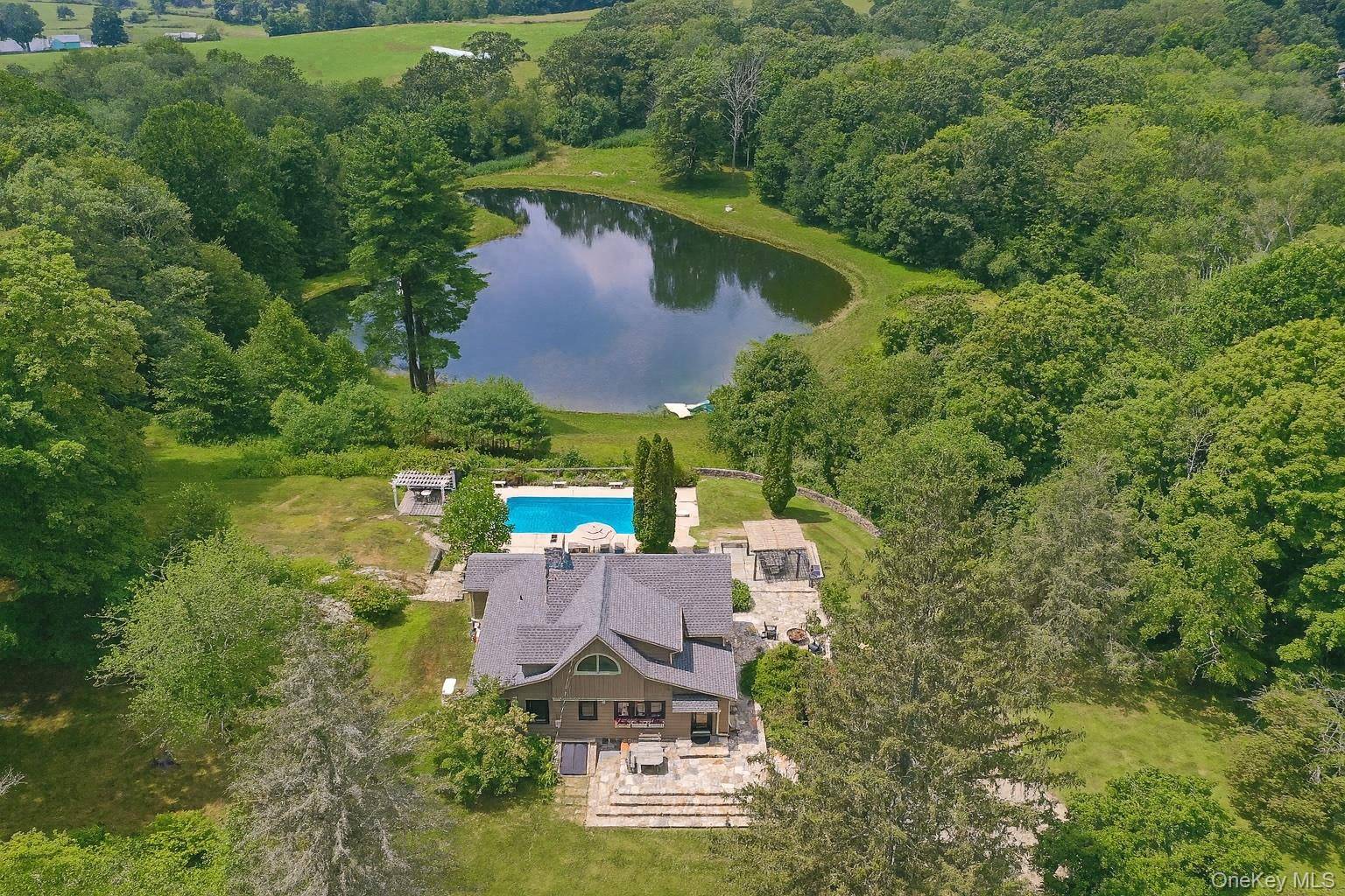 Welcome to 31 Blueberry Lane in Stormville, a unique estate offering two homes and a guest studio on over 17 private acres with stunning natural features, including two ponds and ...