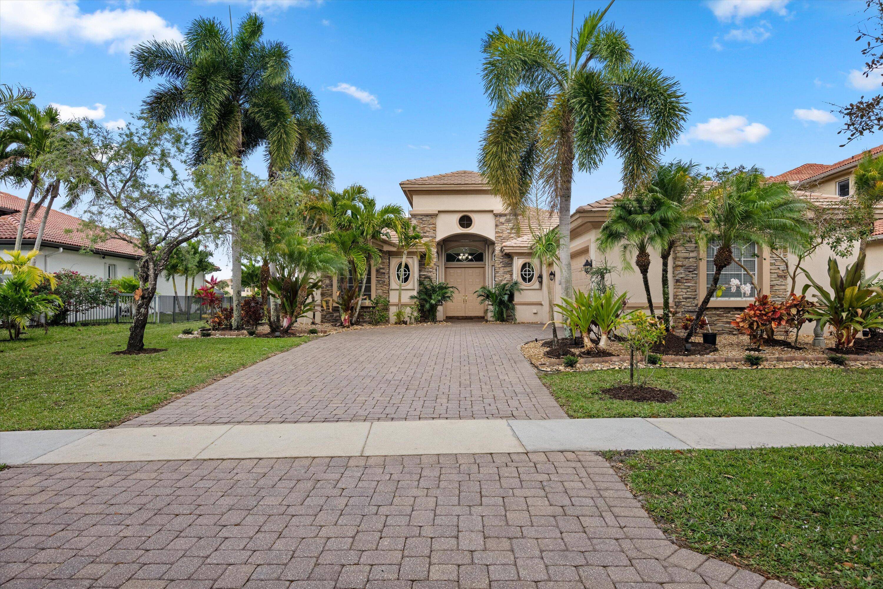 Cozy lakefront pool home in a gated community, offering panoramic lake and preserve views.
