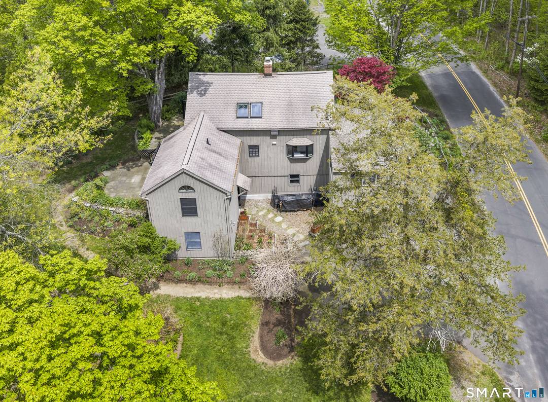 An antique barn with classic New England post and beam construction exposed throughout, set amid a park like garden along a quiet street, with easy access to shopping and I ...