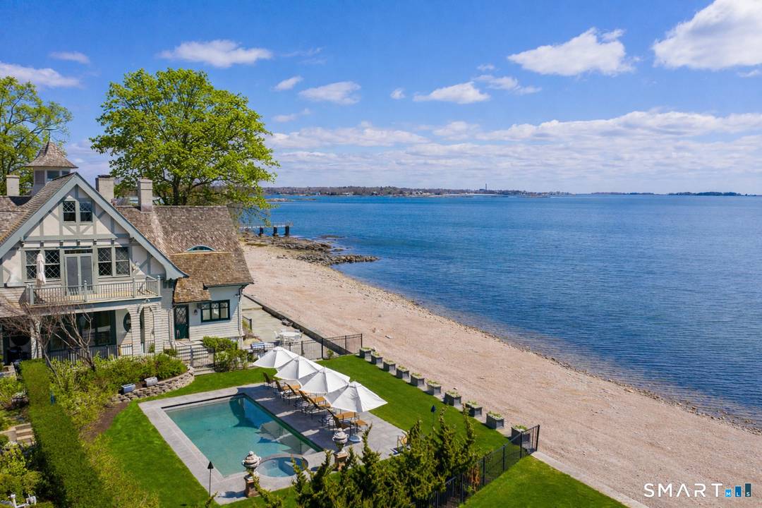 This dramatic property offers 200 feet of waterfront frontage with your own private beach in the premier Long Neck Point area of Darien.