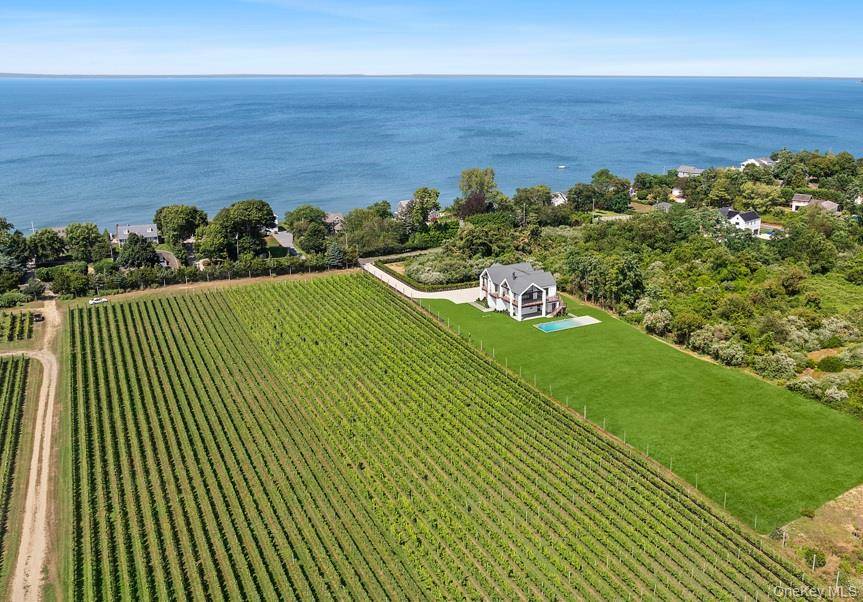 Experience the epitome of luxury living in this modern new construction estate, a truly unique offering on the East End framed by breathtaking vineyard views.