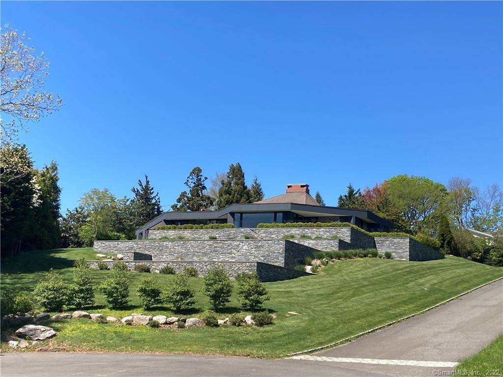 Panoramic water views of Long Island Sound defines this Modern Mid Century Architectural gem set on an acre of beautiful grounds with a heated gunite pool.