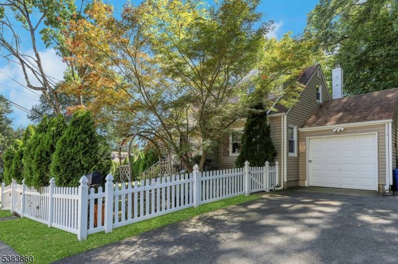 This charming Cape Cod style home nestled on a private corner property offers a perfect blend of classic design and modern comfort.