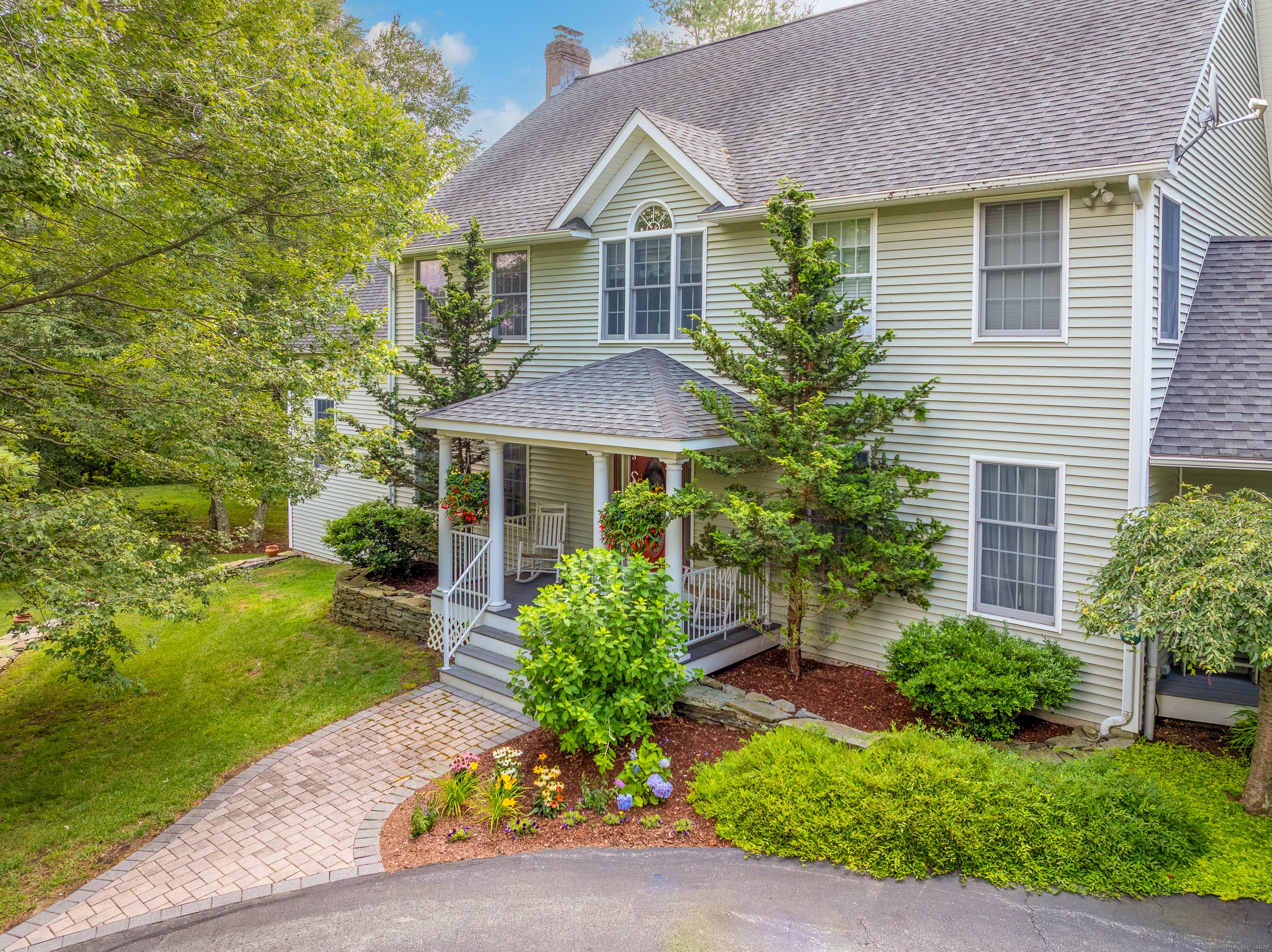 Experience refined New England living in this remarkable Colonial, set on a private, professionally landscaped lot with sweeping panoramic views in Brooklyn's coveted Quiet Corner.