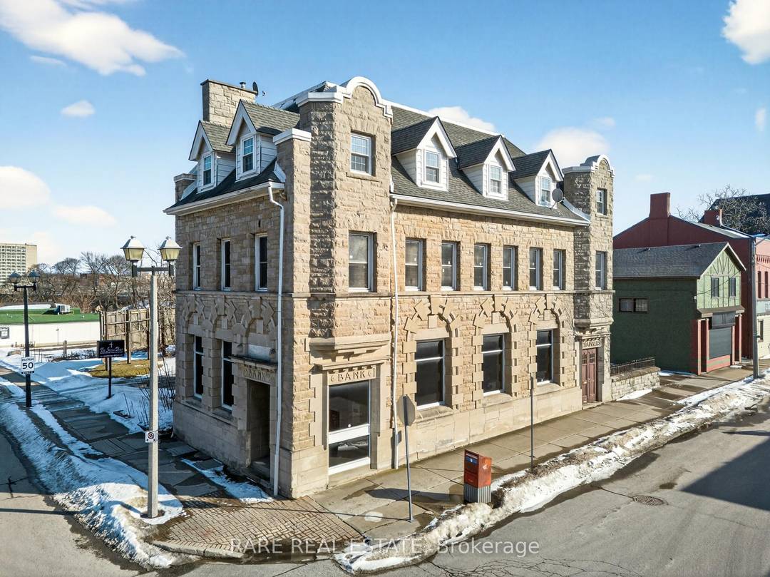 Originally constructed in 1906, this distinguished limestone building showcases a striking blend of Romanesque Revival andFrench Renaissance architectural design, highlighted by its detailed stone fac ade and timeless presence.