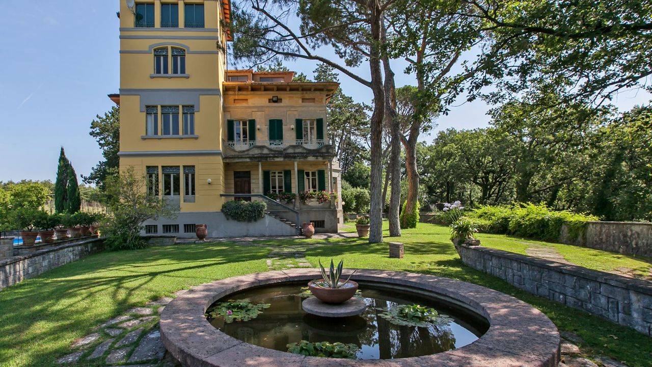 Restored Art Nouveau villa with panoramic views, pool, tennis court, greenhouse, consecrated chapel and private park for sale in Arezzo, Tuscany.